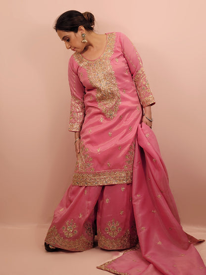 Pink Shimmer Sharara Suit. Heavy Zari Sequins Neckline. Heavy sleeves, bottom and dupatta.