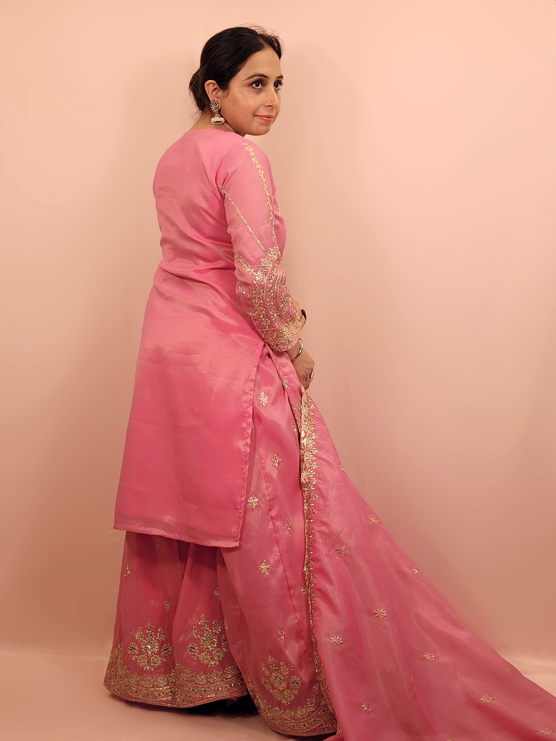 Pink Shimmer Sharara Suit. Heavy Zari Sequins Neckline. Heavy sleeves, bottom and dupatta.