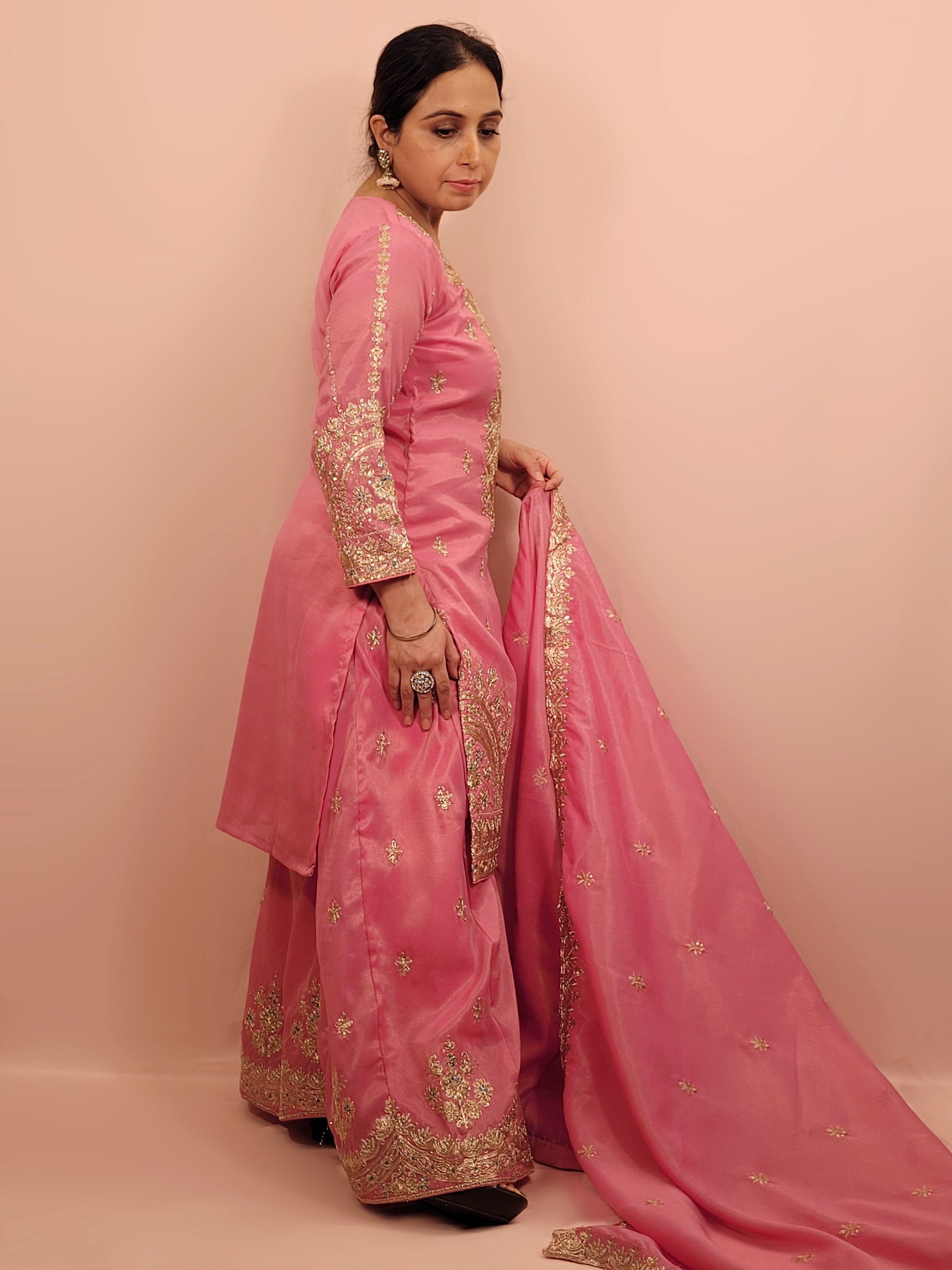 Pink Shimmer Sharara Suit. Heavy Zari Sequins Neckline. Heavy sleeves, bottom and dupatta.
