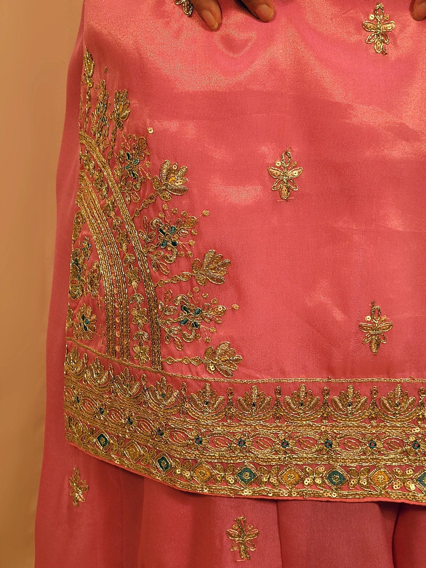 Pink Shimmer Sharara Suit. Heavy Zari Sequins Neckline. Heavy sleeves, bottom and dupatta.
