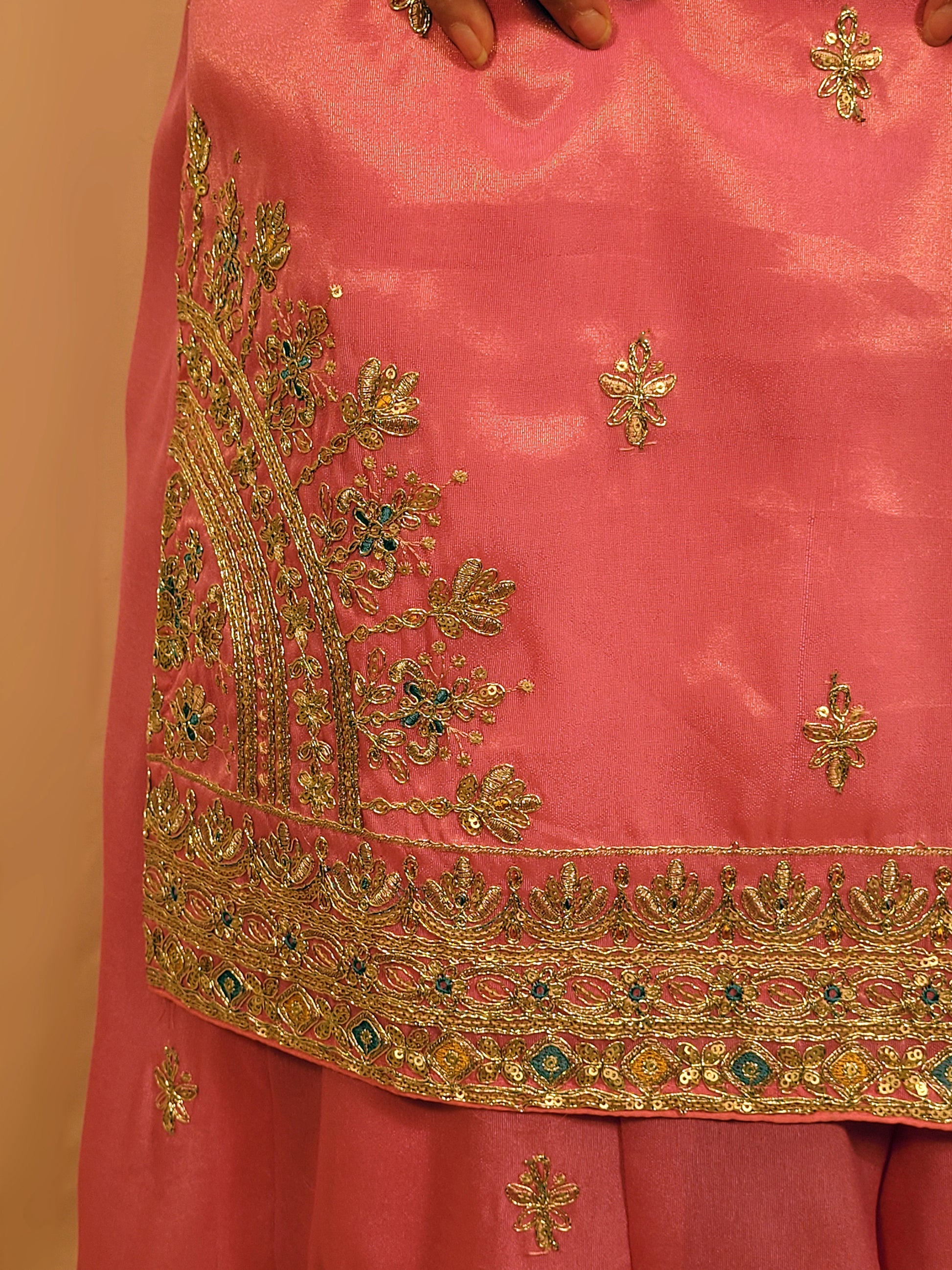 Pink Shimmer Sharara Suit. Heavy Zari Sequins Neckline. Heavy sleeves, bottom and dupatta.