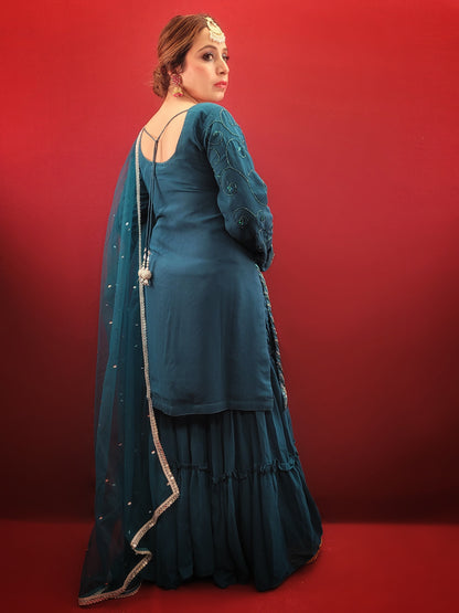 Prussian blue georgette kameez sharara set is the perfect choice for anyone looking for a stylish and elegant outfit for their next party or wedding event. The intricate cutdana, beads and zarkan work on the kameez and sleeves add a touch of glamour and sophistication to the overall design.