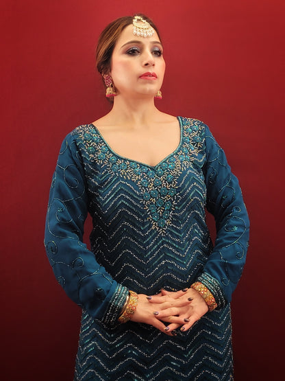 Prussian blue georgette kameez sharara set is the perfect choice for anyone looking for a stylish and elegant outfit for their next party or wedding event. The intricate cutdana, beads and zarkan work on the kameez and sleeves add a touch of glamour and sophistication to the overall design.