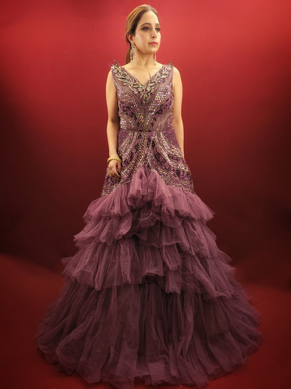 Embrace a captivating silhouette and exquisite detailing with this Onion Net Mermaid Gown. Crafted from luxurious onion net, this gown drapes beautifully, hugging your curves and flaring out dramatically at the knee to create a stunning mermaid silhouette. The true showstopper, however, is the handcrafted embellishment on the front.