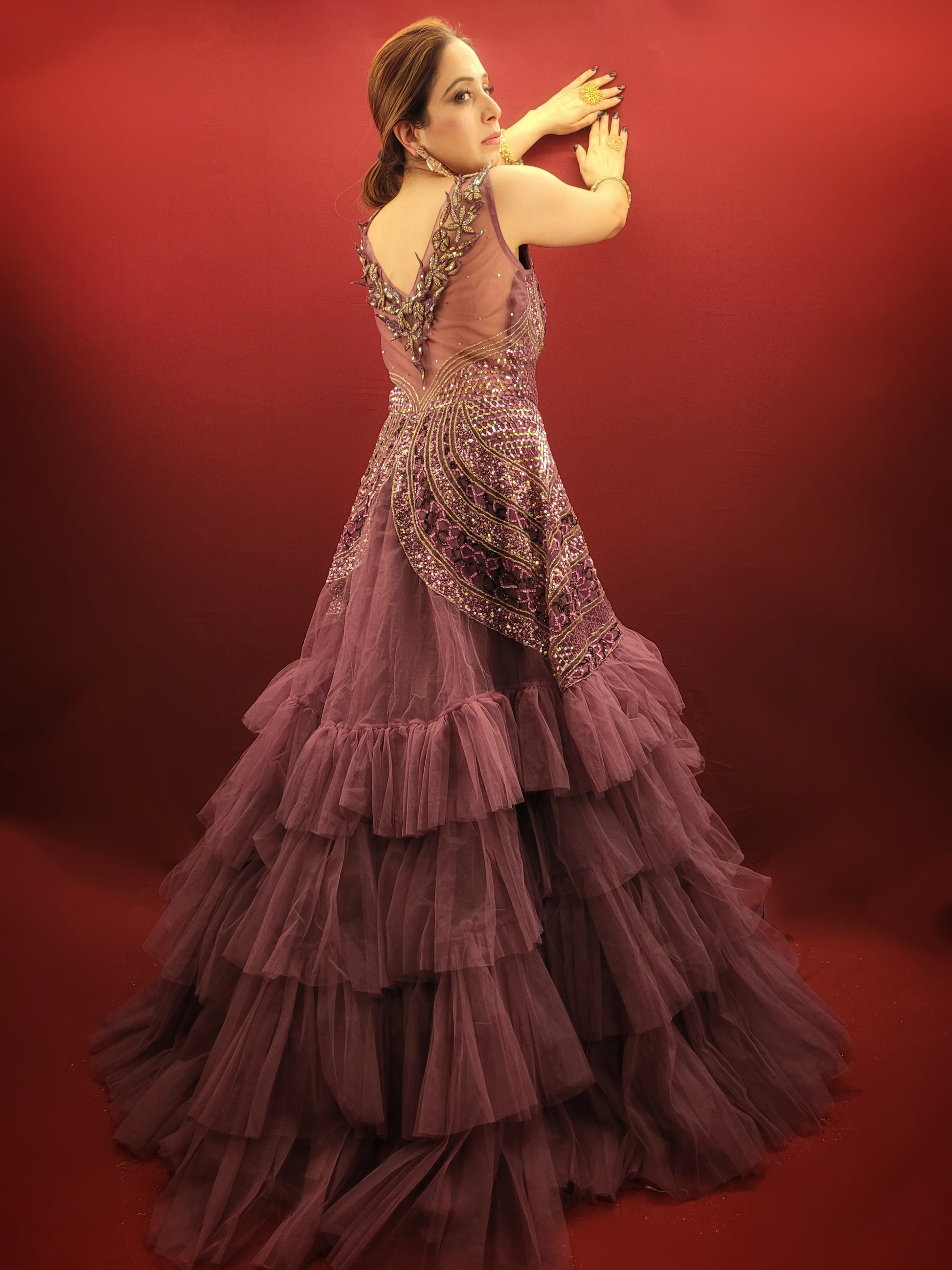 Embrace a captivating silhouette and exquisite detailing with this Onion Net Mermaid Gown. Crafted from luxurious onion net, this gown drapes beautifully, hugging your curves and flaring out dramatically at the knee to create a stunning mermaid silhouette. The true showstopper, however, is the handcrafted embellishment on the front.