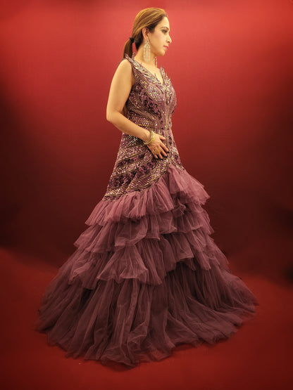 Embrace a captivating silhouette and exquisite detailing with this Onion Net Mermaid Gown. Crafted from luxurious onion net, this gown drapes beautifully, hugging your curves and flaring out dramatically at the knee to create a stunning mermaid silhouette. The true showstopper, however, is the handcrafted embellishment on the front.