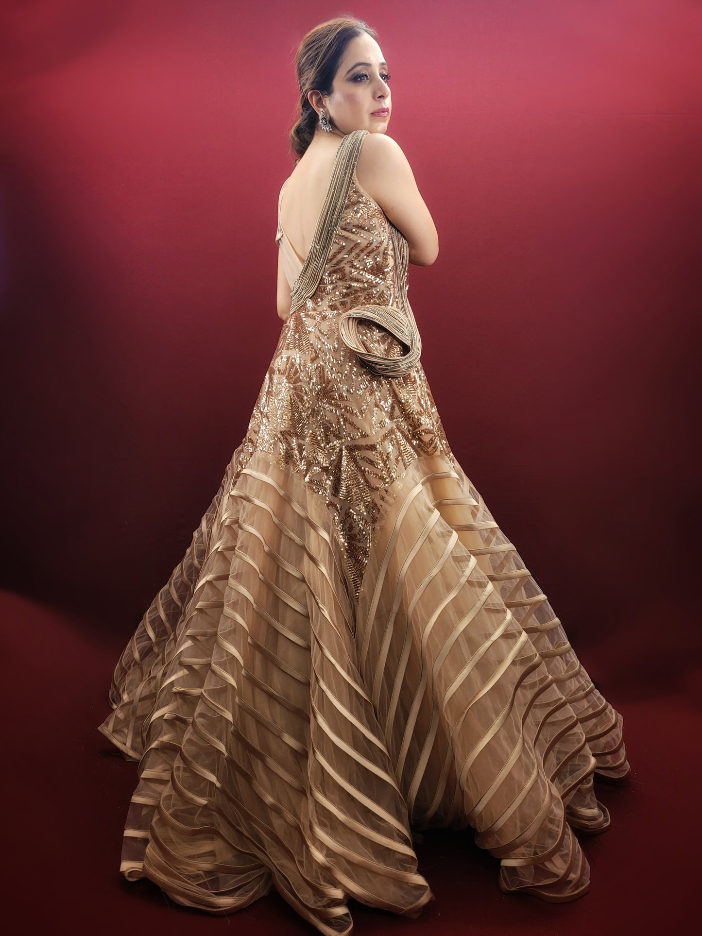 Embrace the drama and elegance of couture fashion with this Golden Beige Gown, inspired by the visionary designs of Gaurav Gupta. Crafted from delicate net fabric, this gown drapes effortlessly, creating a silhouette that is both ethereal and unforgettable.