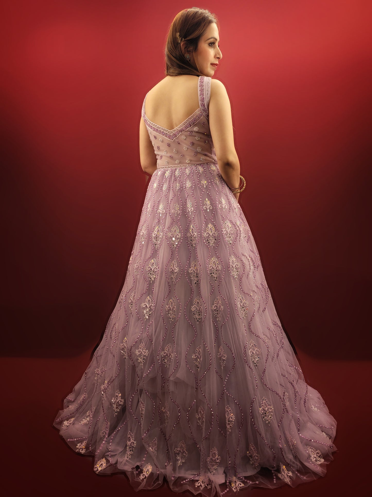 Be the star of your own fairytale with this mesmerizing Lavender Net Gown. Crafted from layers of light-as-air net, this gown drapes effortlessly, creating a silhouette that is both romantic and undeniably glamorous. Prepare to be swept away by the exquisite embellishments adorning this captivating piece.