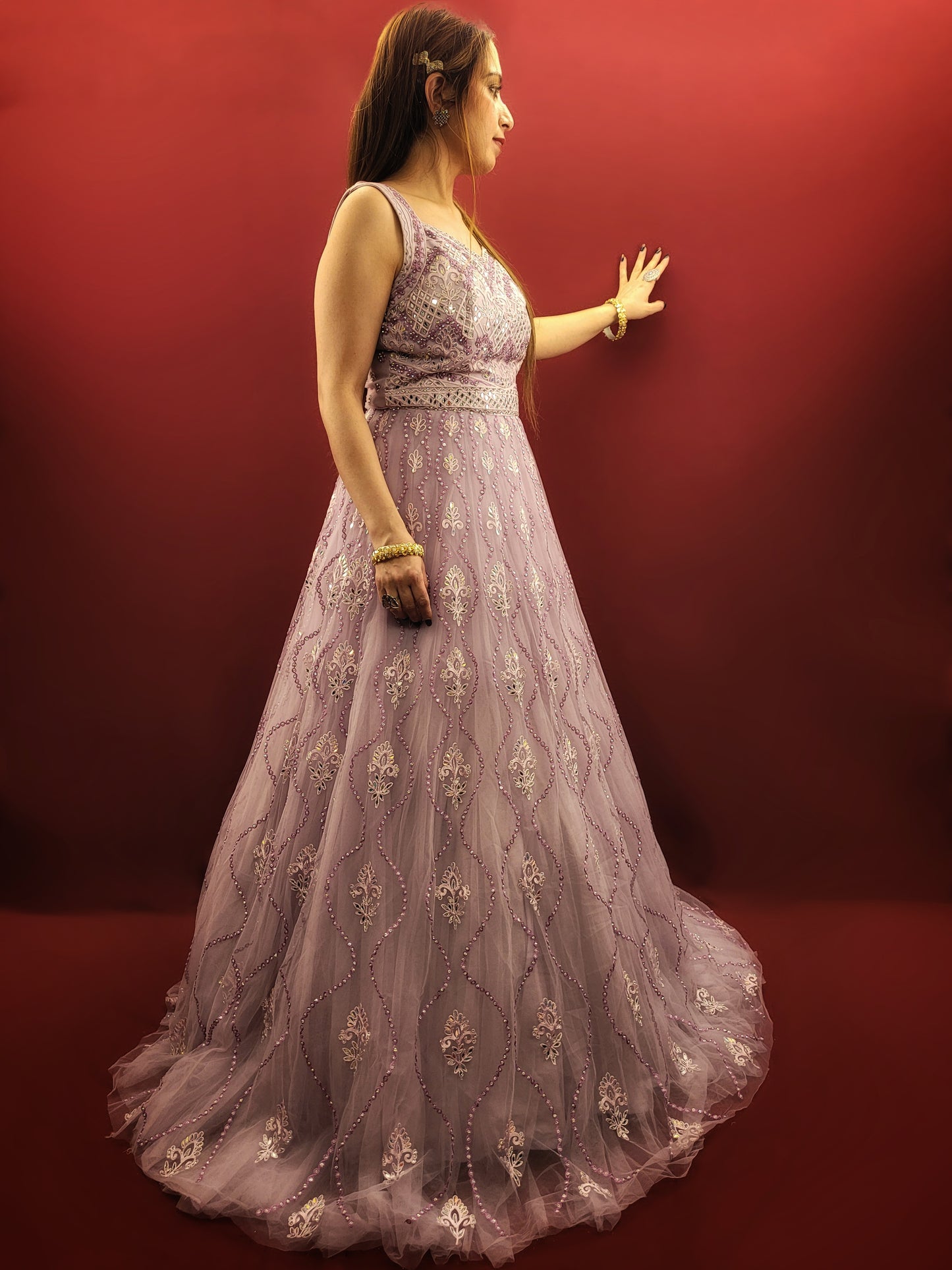 Be the star of your own fairytale with this mesmerizing Lavender Net Gown. Crafted from layers of light-as-air net, this gown drapes effortlessly, creating a silhouette that is both romantic and undeniably glamorous. Prepare to be swept away by the exquisite embellishments adorning this captivating piece.