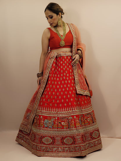 Lehenga:&nbsp;Crafted from luxurious silk, this red bridal lehenga is adorned with intricate multicolor embroidery using Resham, Zari, and Zarkan techniques. The heavy embroidery showcases the rich heritage of Indian craftsmanship, making it a perfect choice for brides.
Blouse:&nbsp;The set comes with a heavily embroidered unstitched blouse, allowing you to tailor it to your perfect fit. Please note, the blouse worn by the model is for reference purposes only.