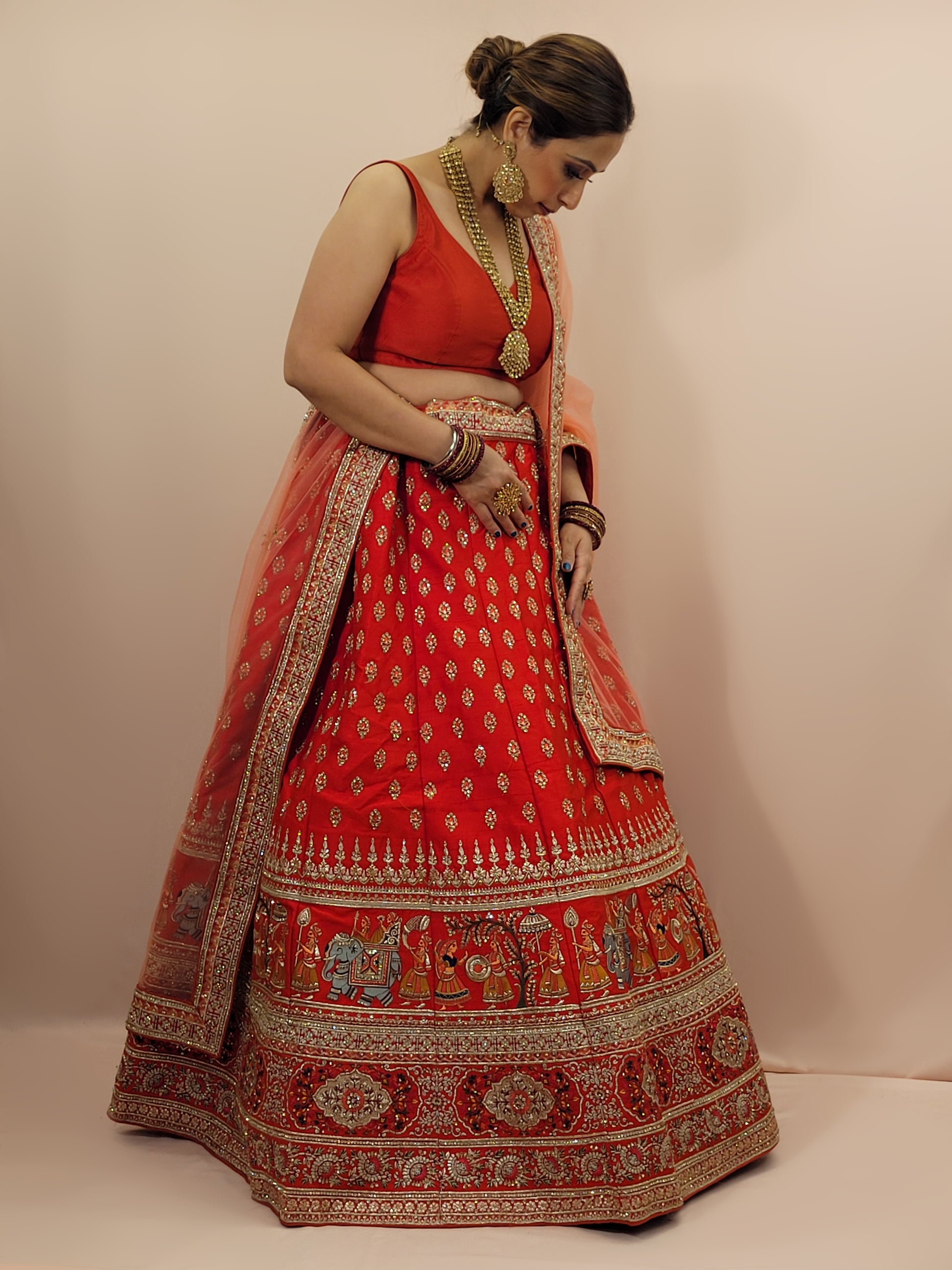 Lehenga:&nbsp;Crafted from luxurious silk, this red bridal lehenga is adorned with intricate multicolor embroidery using Resham, Zari, and Zarkan techniques. The heavy embroidery showcases the rich heritage of Indian craftsmanship, making it a perfect choice for brides.
Blouse:&nbsp;The set comes with a heavily embroidered unstitched blouse, allowing you to tailor it to your perfect fit. Please note, the blouse worn by the model is for reference purposes only.