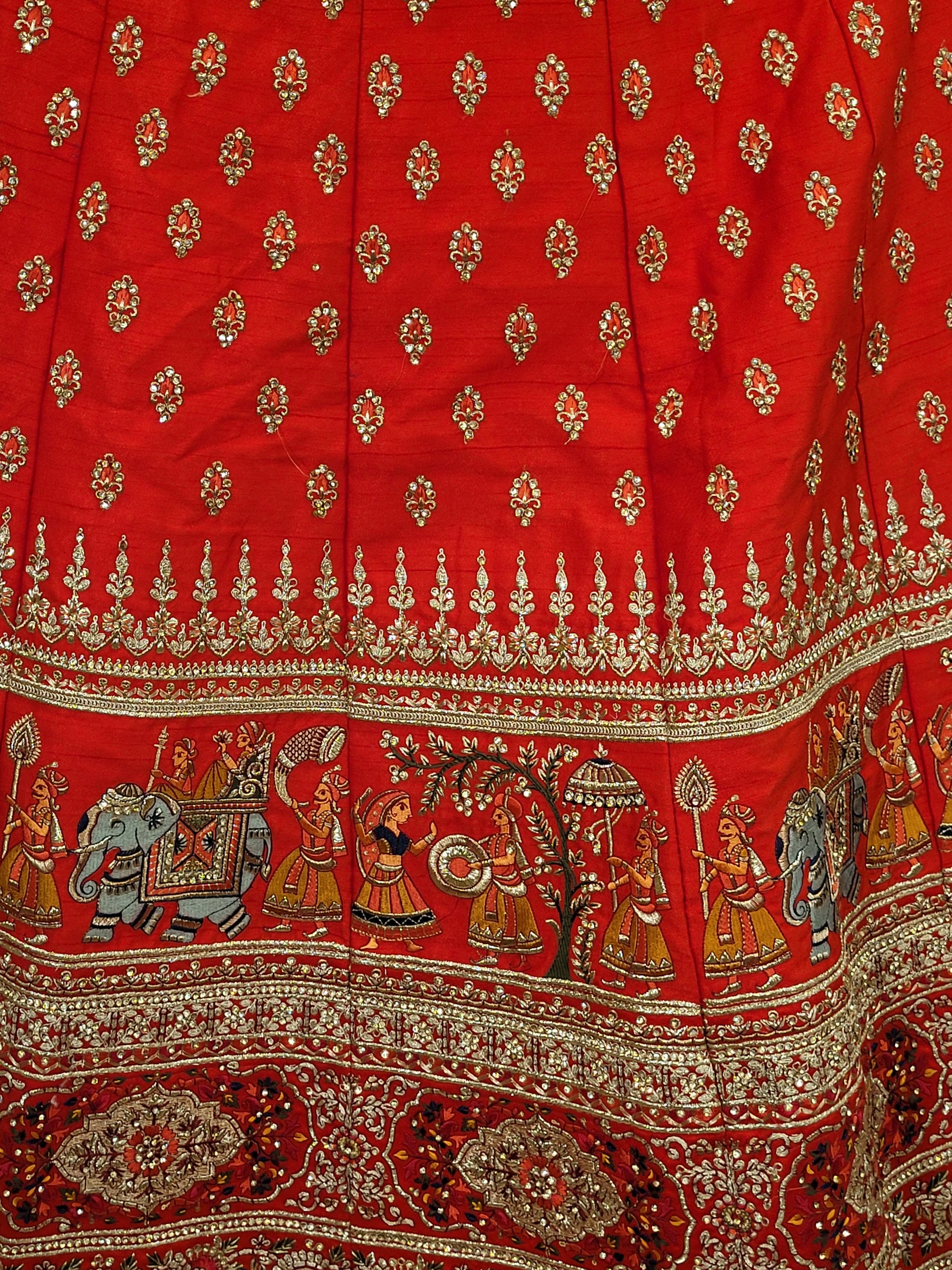 Lehenga:&nbsp;Crafted from luxurious silk, this red bridal lehenga is adorned with intricate multicolor embroidery using Resham, Zari, and Zarkan techniques. The heavy embroidery showcases the rich heritage of Indian craftsmanship, making it a perfect choice for brides.
Blouse:&nbsp;The set comes with a heavily embroidered unstitched blouse, allowing you to tailor it to your perfect fit. Please note, the blouse worn by the model is for reference purposes only.