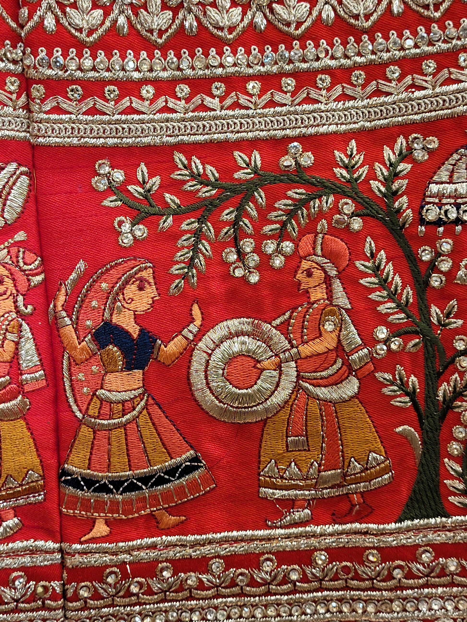 Lehenga:&nbsp;Crafted from luxurious silk, this red bridal lehenga is adorned with intricate multicolor embroidery using Resham, Zari, and Zarkan techniques. The heavy embroidery showcases the rich heritage of Indian craftsmanship, making it a perfect choice for brides.
Blouse:&nbsp;The set comes with a heavily embroidered unstitched blouse, allowing you to tailor it to your perfect fit. Please note, the blouse worn by the model is for reference purposes only.