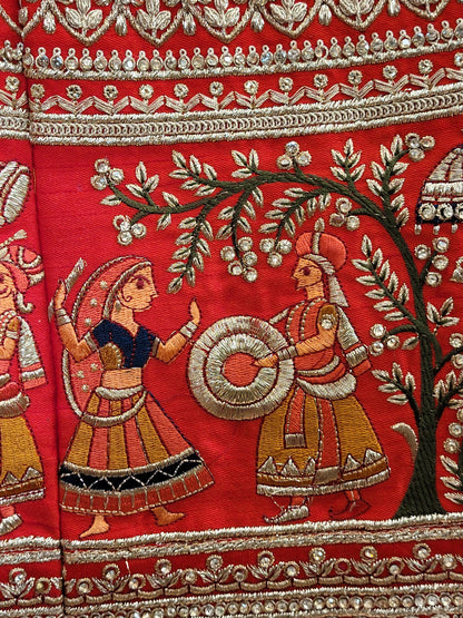 Lehenga:&nbsp;Crafted from luxurious silk, this red bridal lehenga is adorned with intricate multicolor embroidery using Resham, Zari, and Zarkan techniques. The heavy embroidery showcases the rich heritage of Indian craftsmanship, making it a perfect choice for brides.
Blouse:&nbsp;The set comes with a heavily embroidered unstitched blouse, allowing you to tailor it to your perfect fit. Please note, the blouse worn by the model is for reference purposes only.